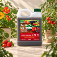 YARDi Fruit & Bloom 2-15-15 liquid fertilizer 32 oz bottle among tomatoes, nasturtiums and strawberries